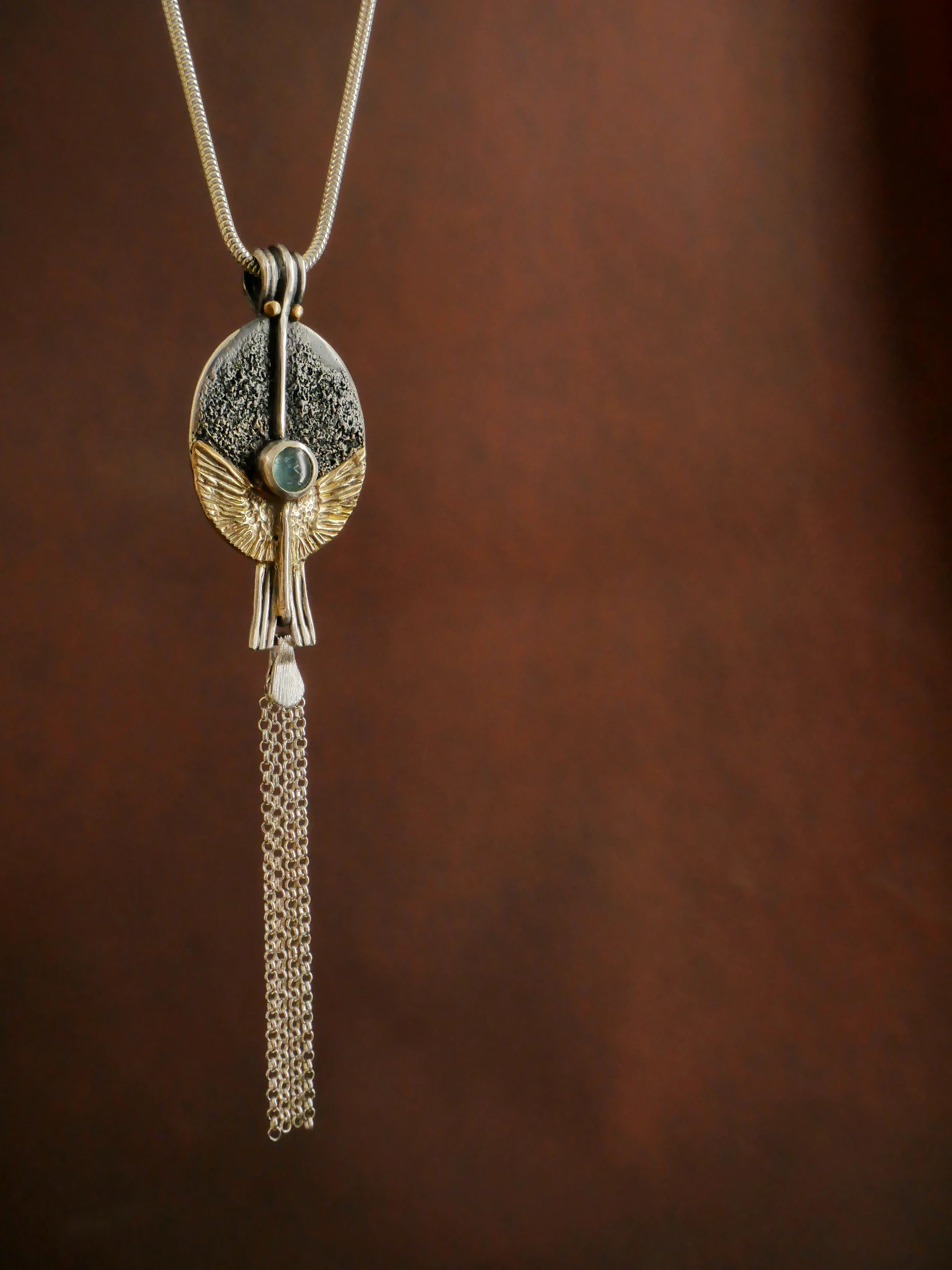 Eliz'art artisan pendant – sterling silver egg, spread 14k gold wings, vertical axis and blue tourmaline, unique creation Bordeaux